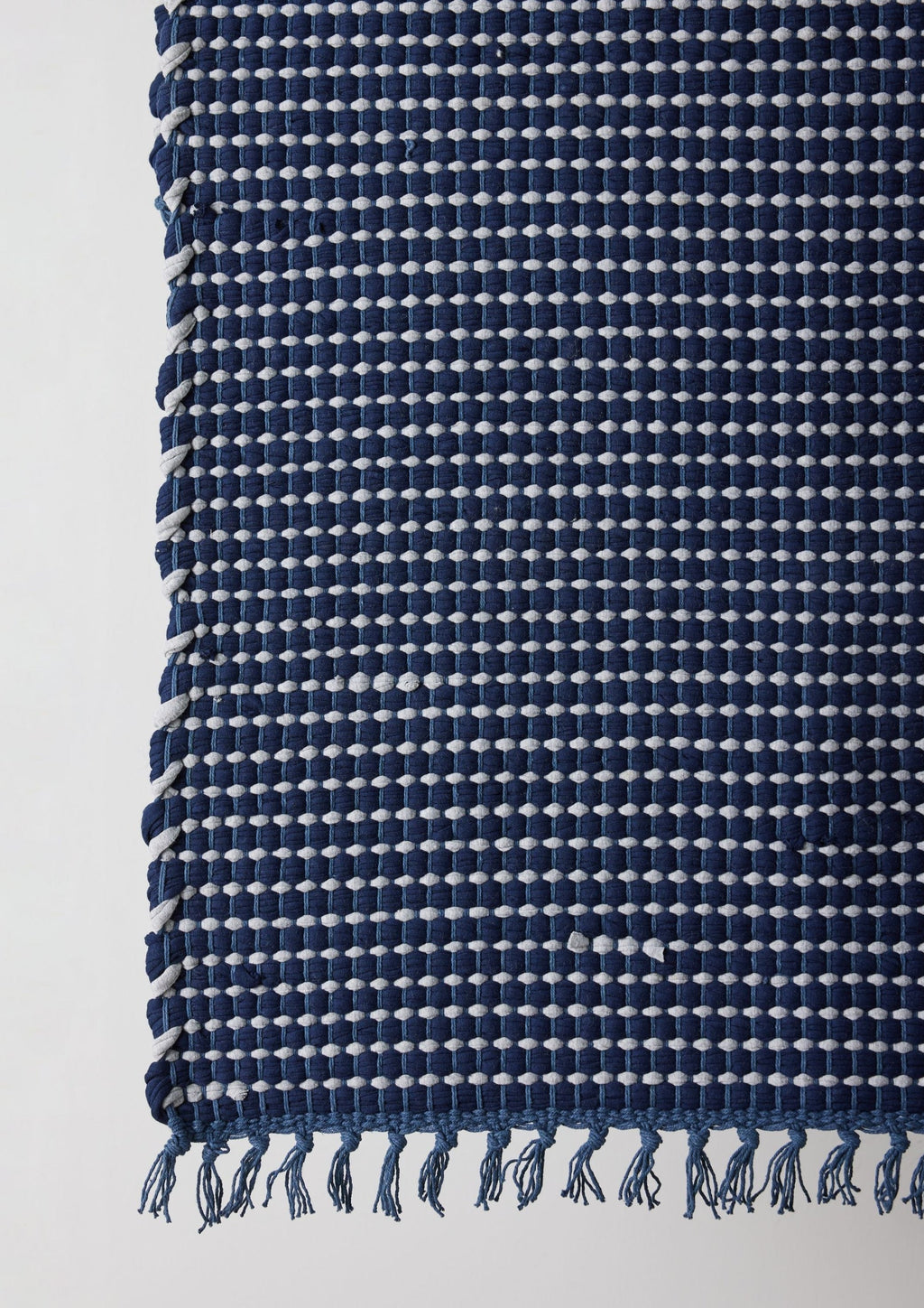Lifestyle photo showing Riverweave Navy Blue Hand-Loomed Cotton Mat in use - Kanju Interiors