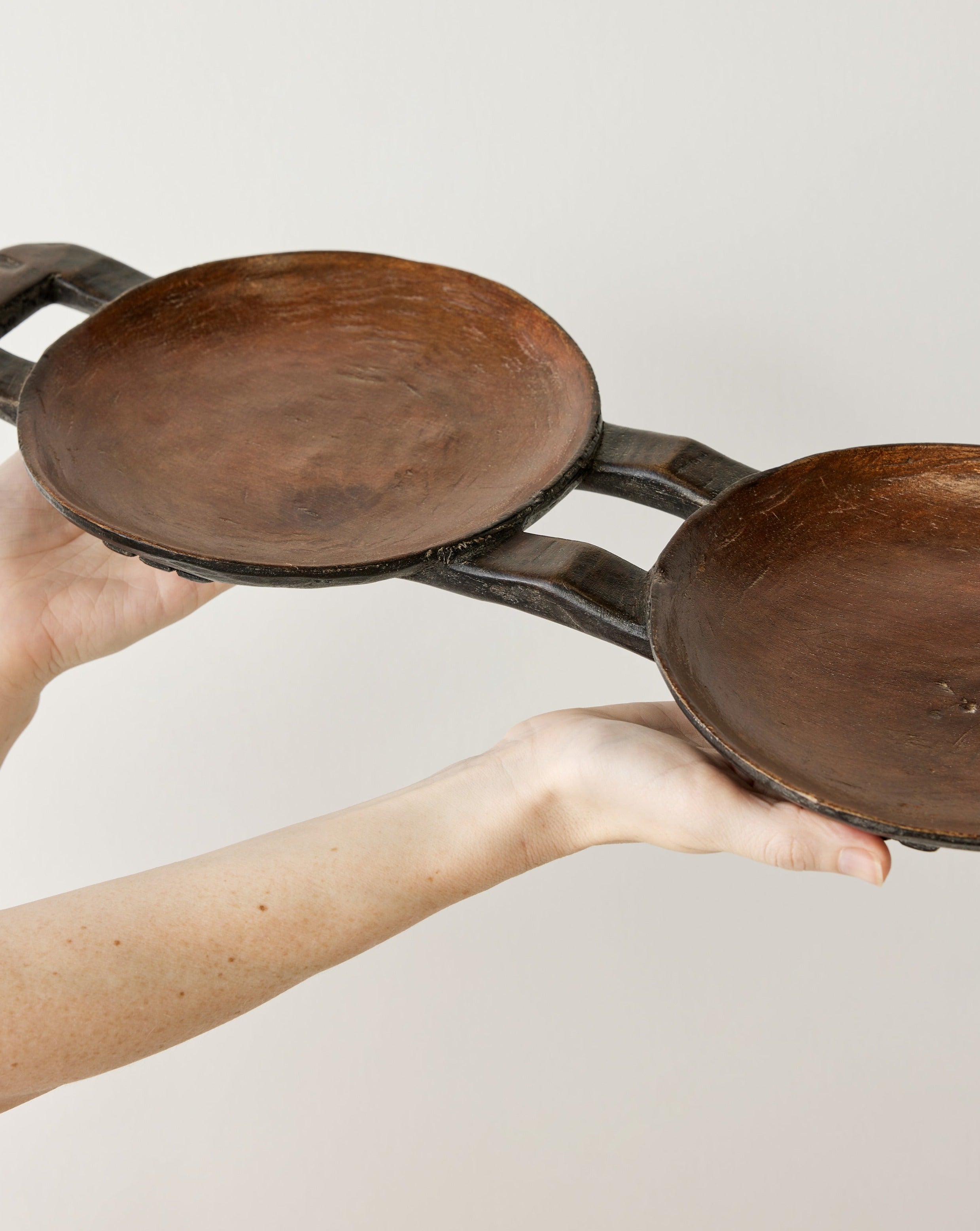 Lifestyle photo showing Bamenda Duo Circular Wooden Serving Tray in use - Kanju Interiors