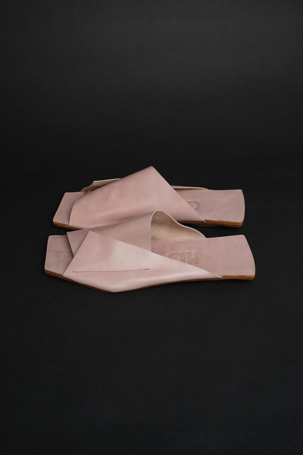 Lifestyle photo showing Amos Handcrafted Pink Leather Slides in use - NINObrand