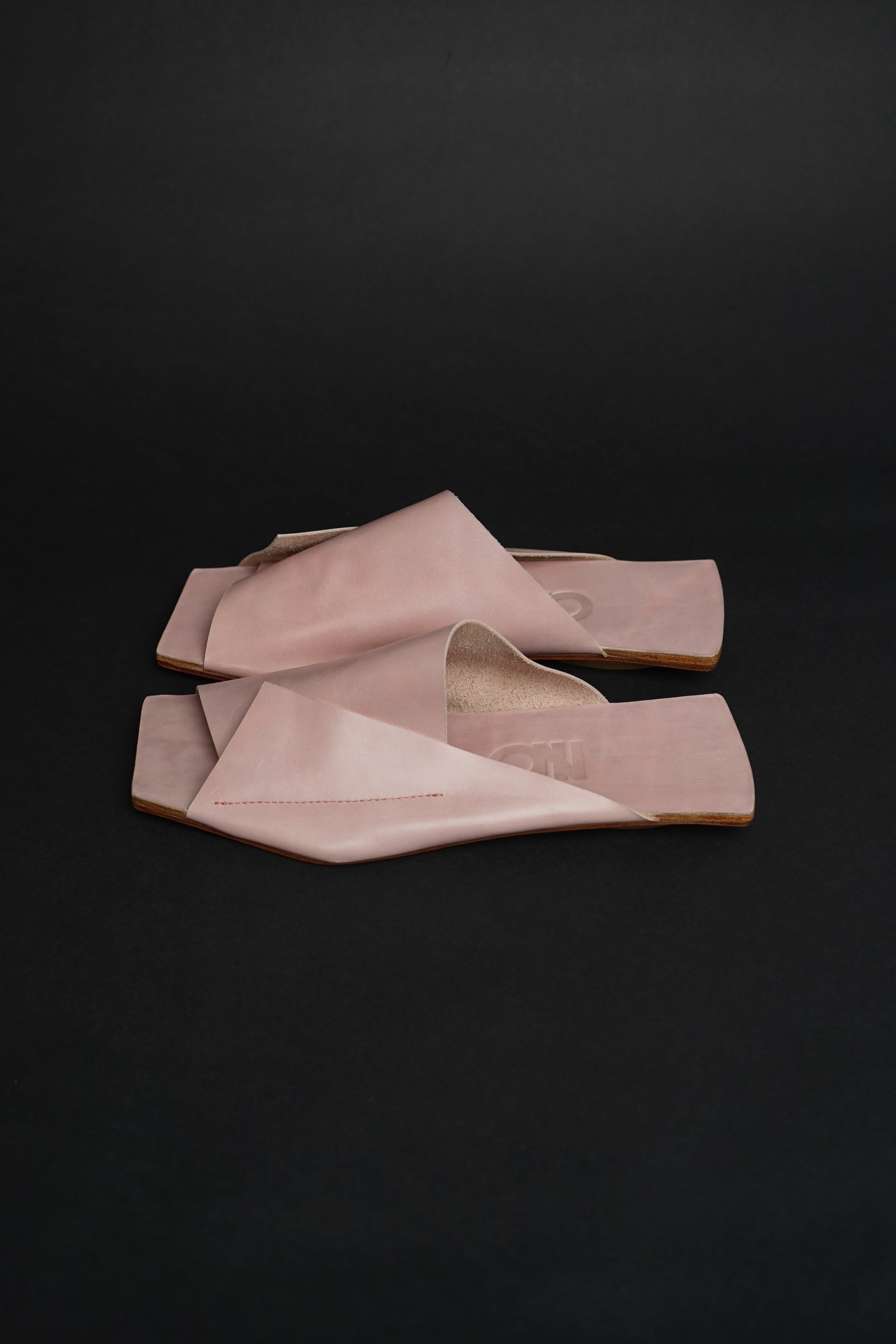 Lifestyle photo showing Amos Handcrafted Pink Leather Slides in use - NINObrand