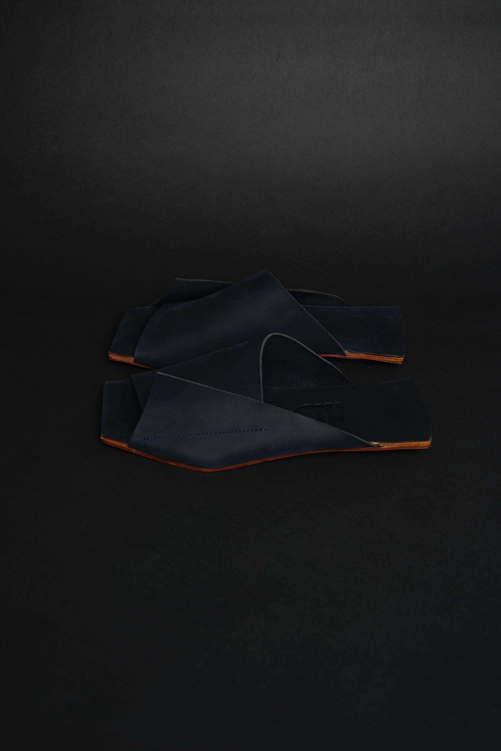 Lifestyle photo showing Amos Handcrafted Navy Leather Slides in use - NINObrand