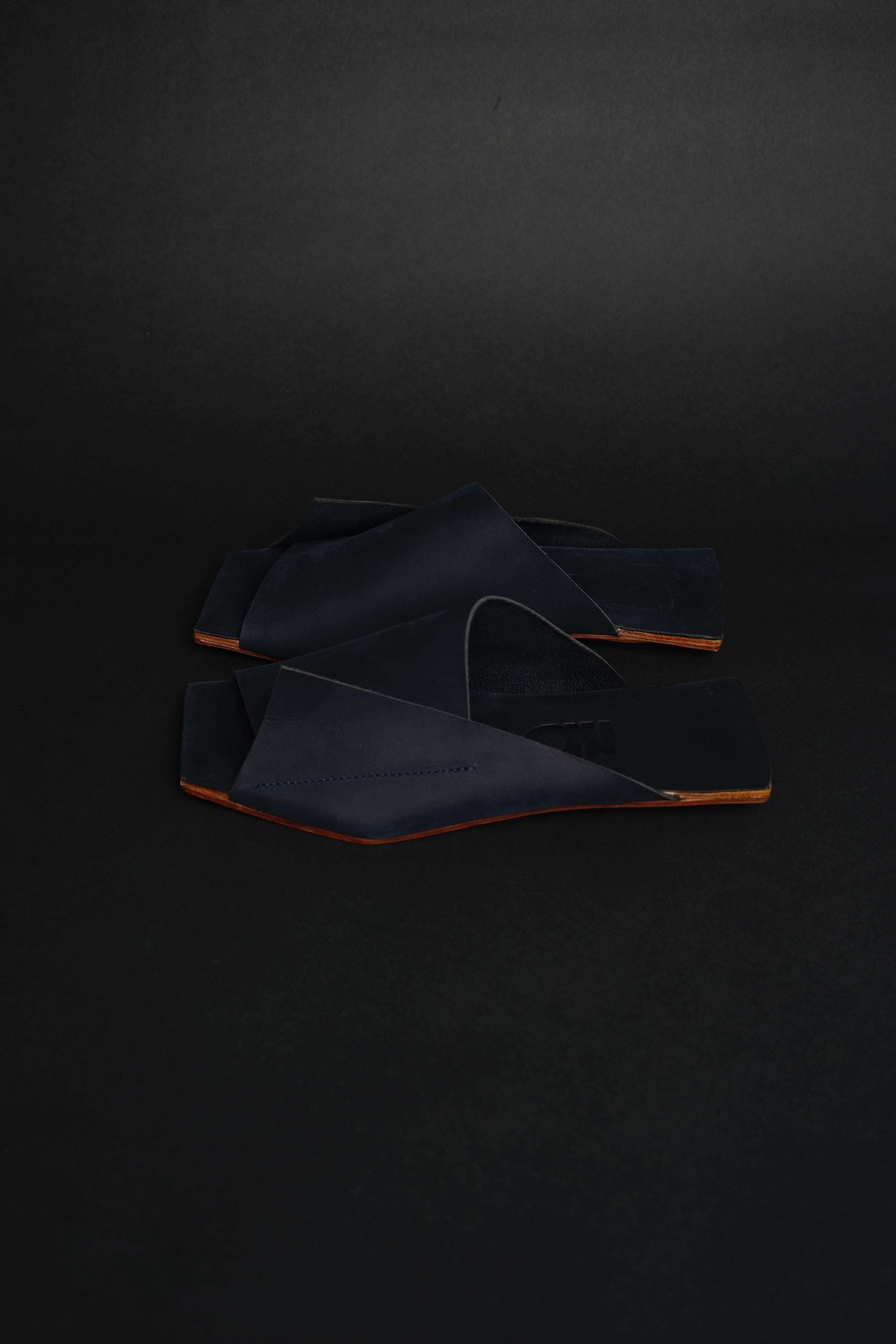 Lifestyle photo showing Amos Handcrafted Navy Leather Slides in use - NINObrand