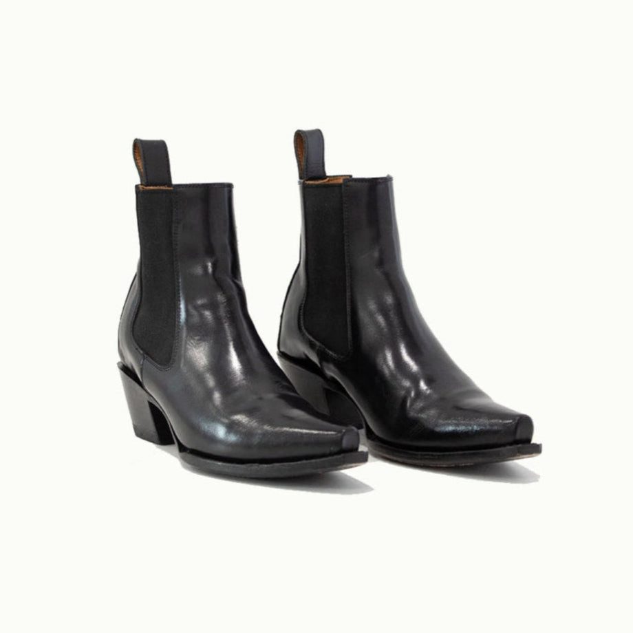 Lifestyle photo showing M-O-NINE The Sandra Boot in Black Patent Leather in use - M-O-NINE