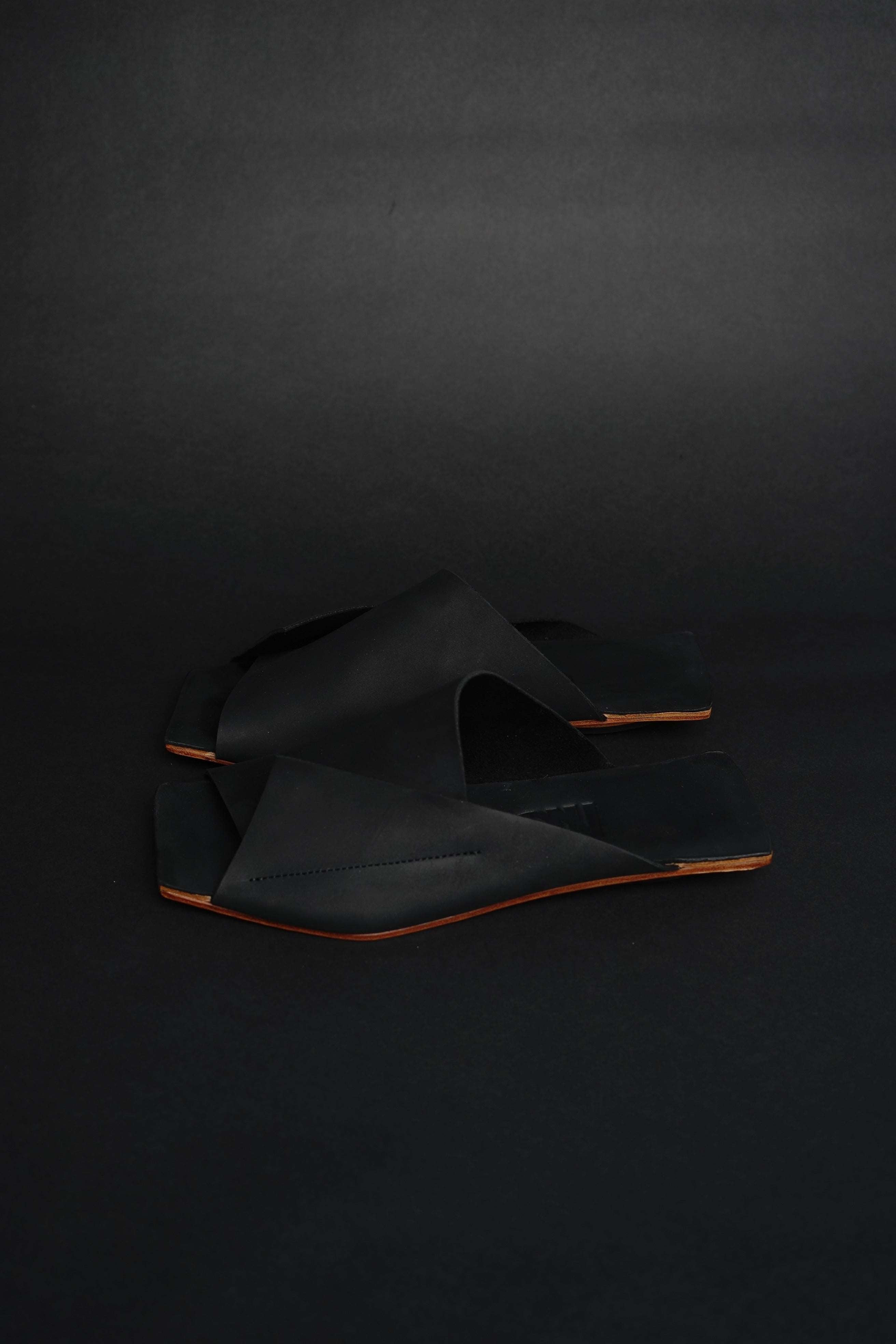 Lifestyle photo showing Amos Handcrafted Black Leather Slides in use - NINObrand