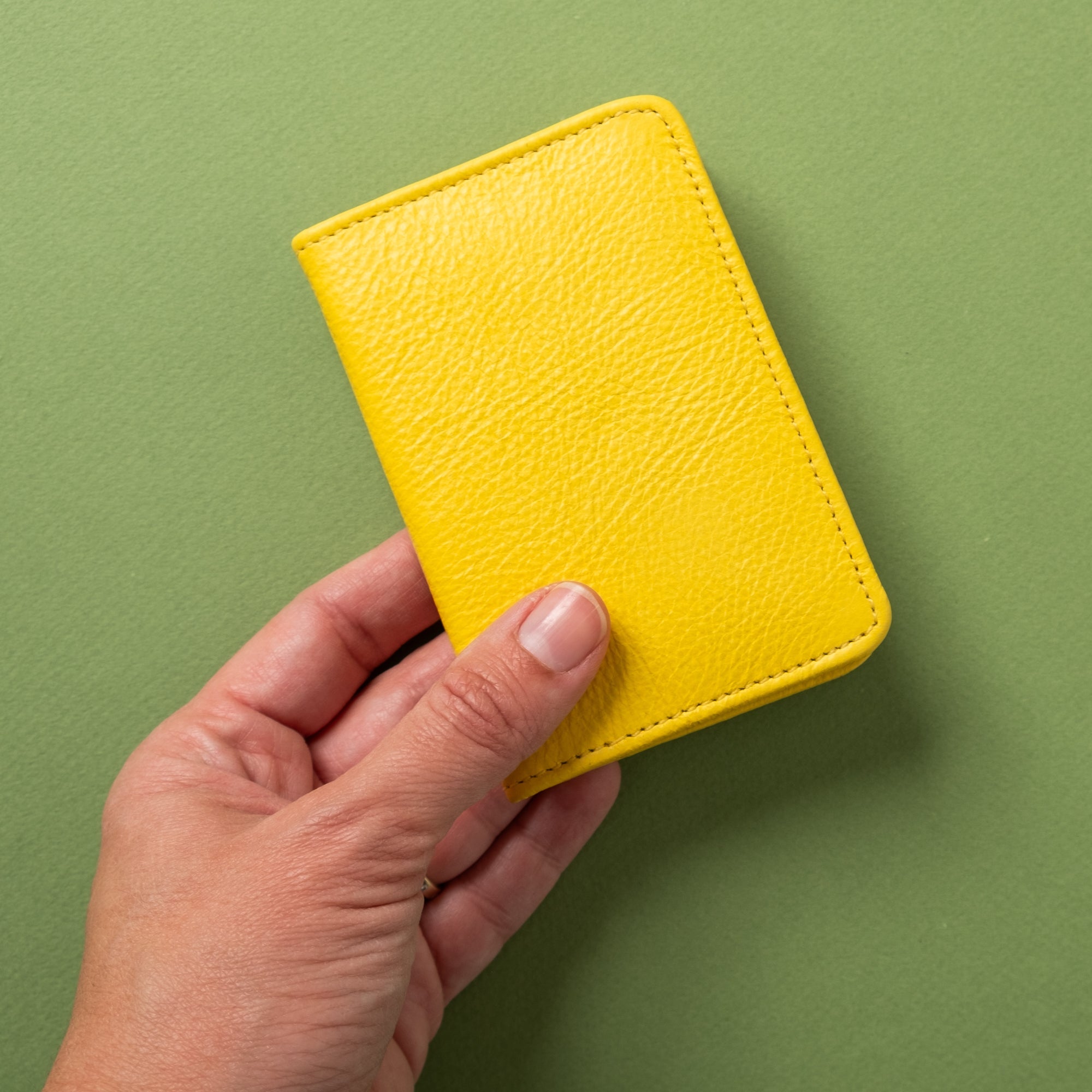 Lifestyle photo showing Compact Bifold with RFID Protection - Sunny Yellow in use - CASUPO