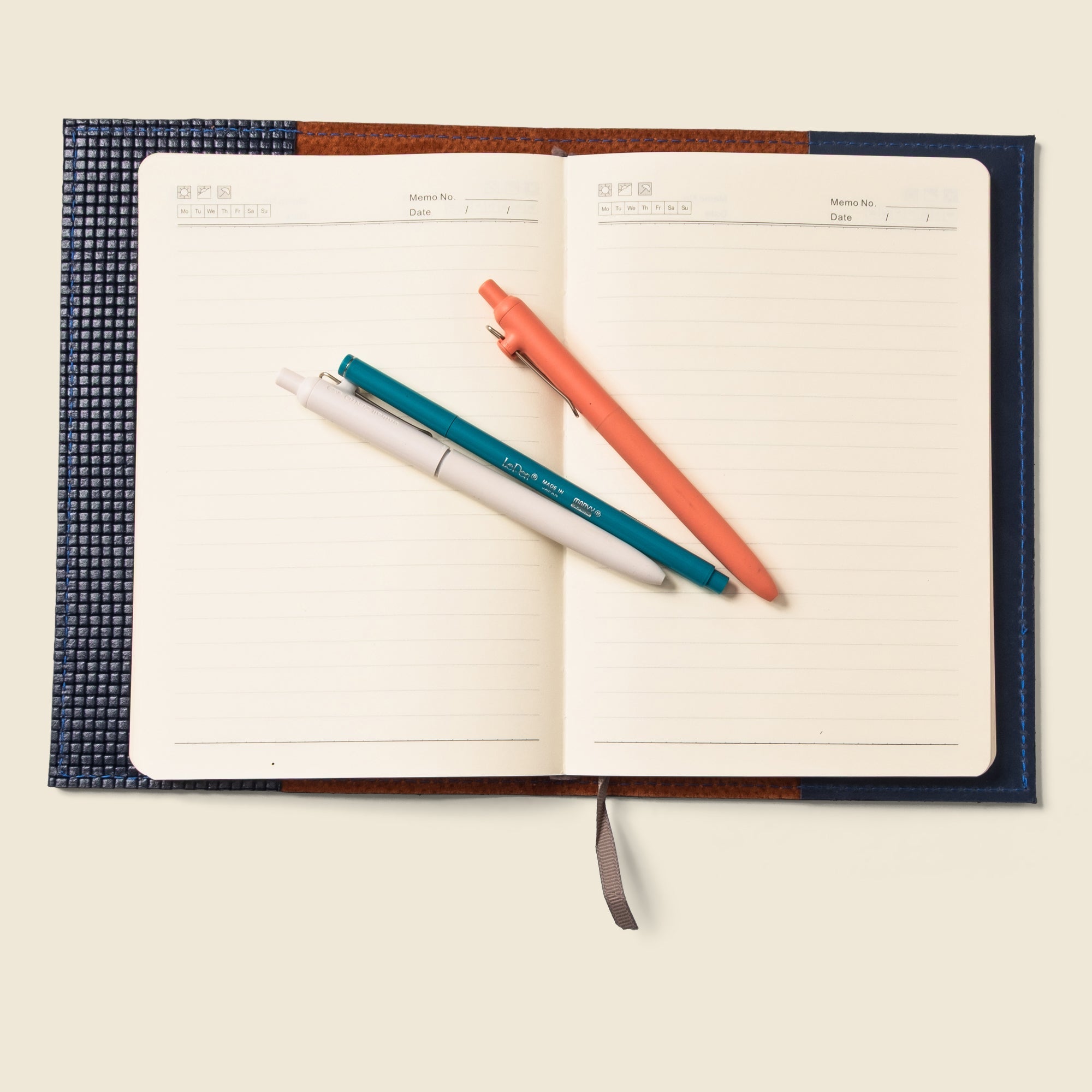 Lifestyle photo showing Refillable A5 Leather Notebook Cover – Navy Limited Edition in use - CASUPO
