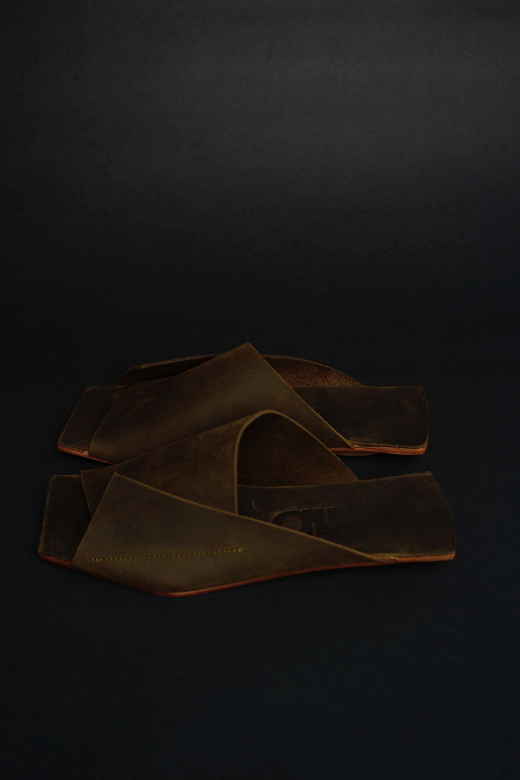Lifestyle photo showing Amos Handcrafted Olive Leather Slides in use - NINObrand