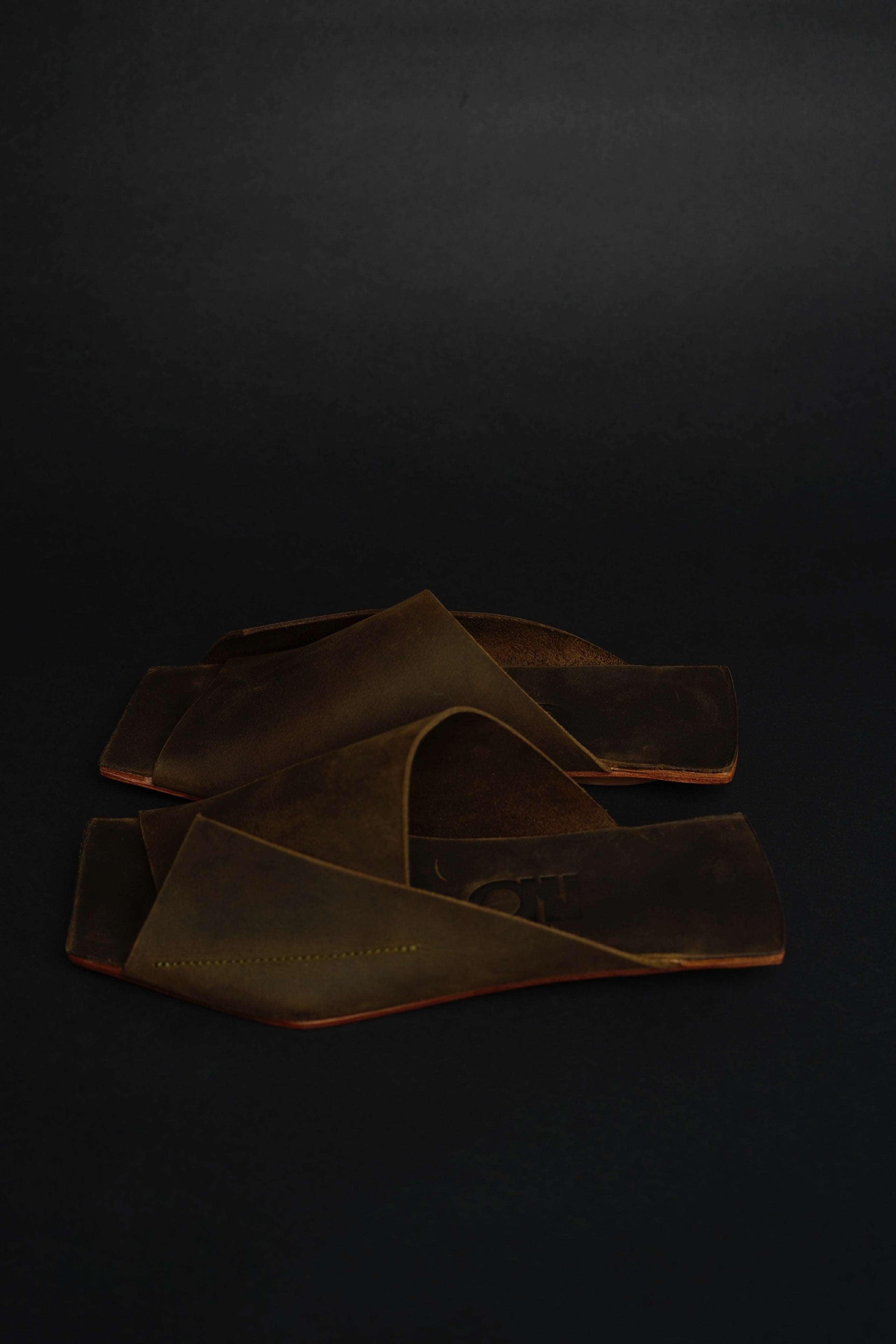 Lifestyle photo showing Amos Handcrafted Olive Leather Slides in use - NINObrand