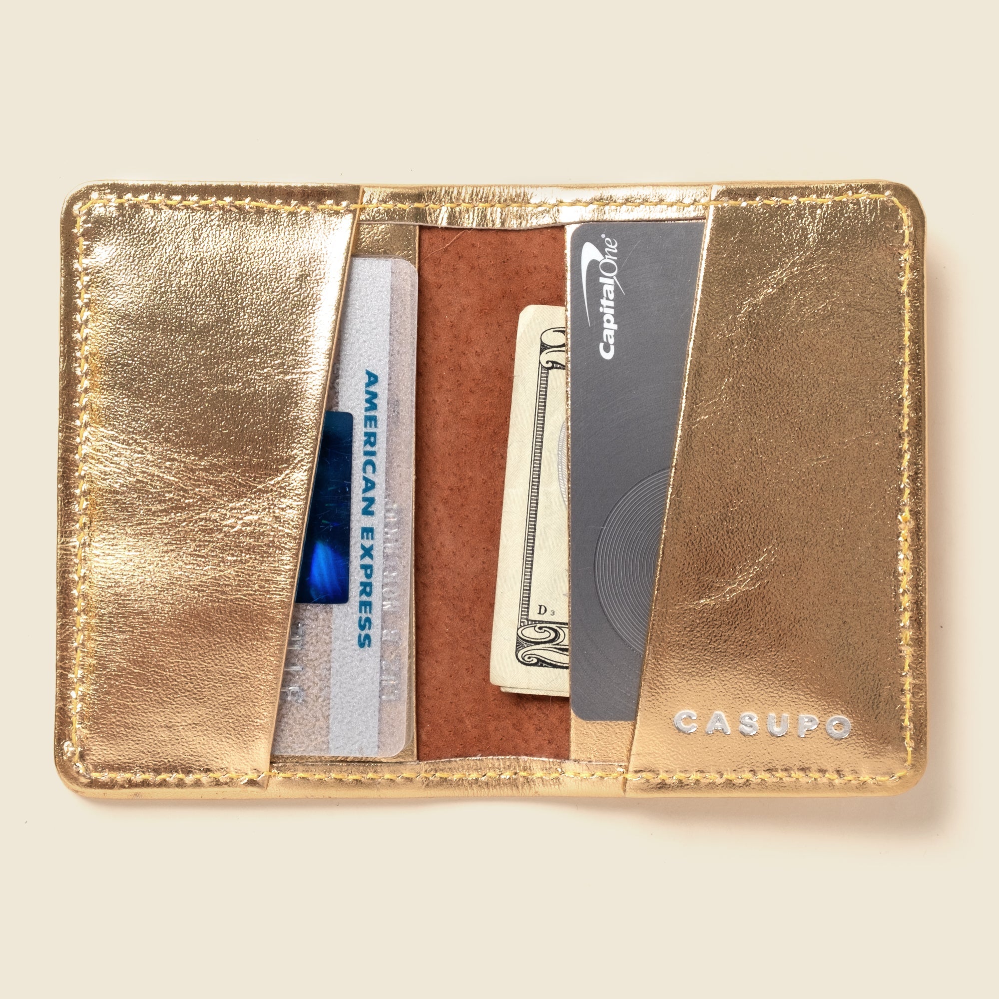 Lifestyle photo showing Compact Bifold with RFID Protection - Gold in use - CASUPO