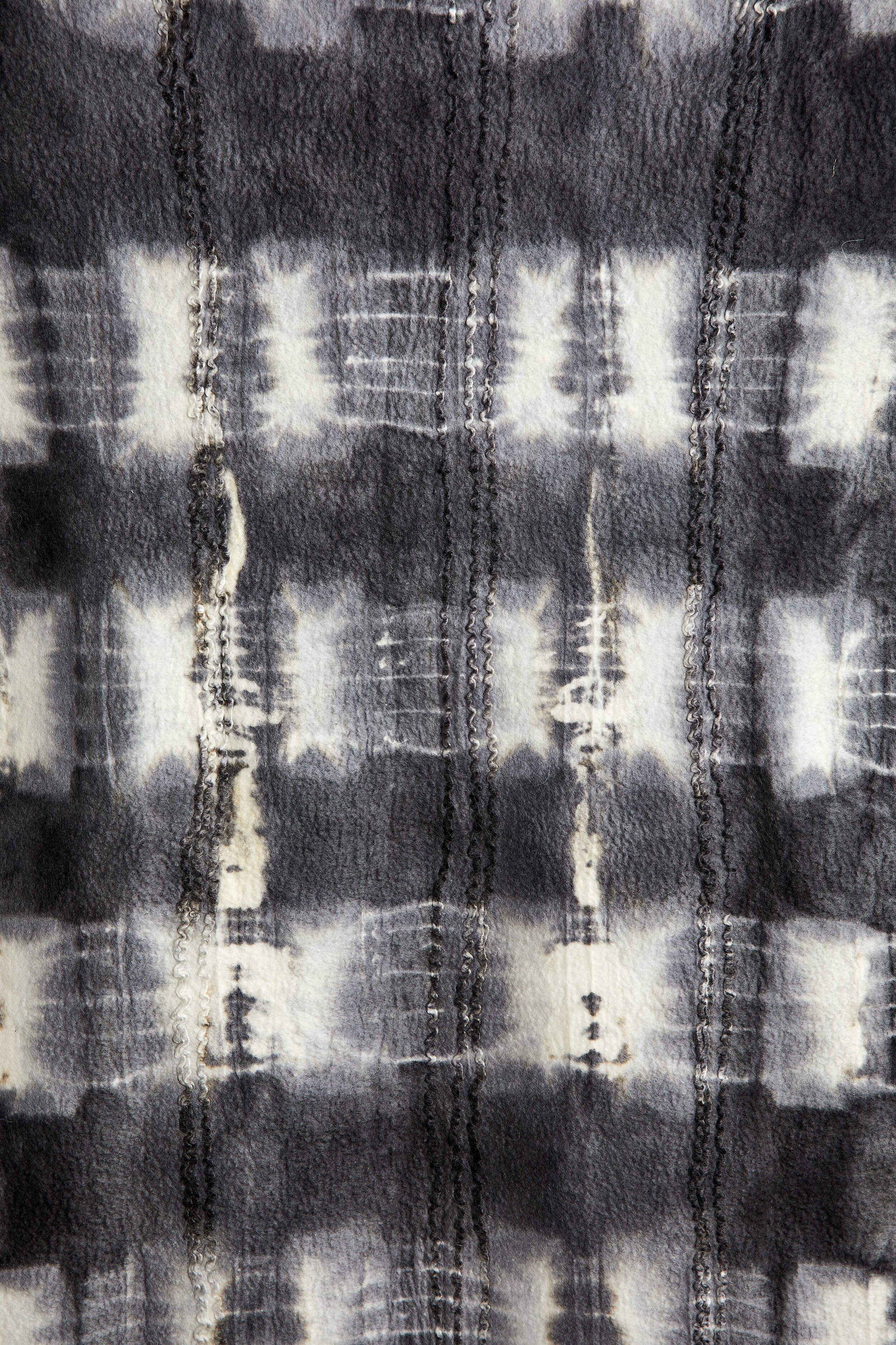 Lifestyle photo showing Adire Tye-Dye Lightweight Wool Throw Blanket in use - Kanju Interiors