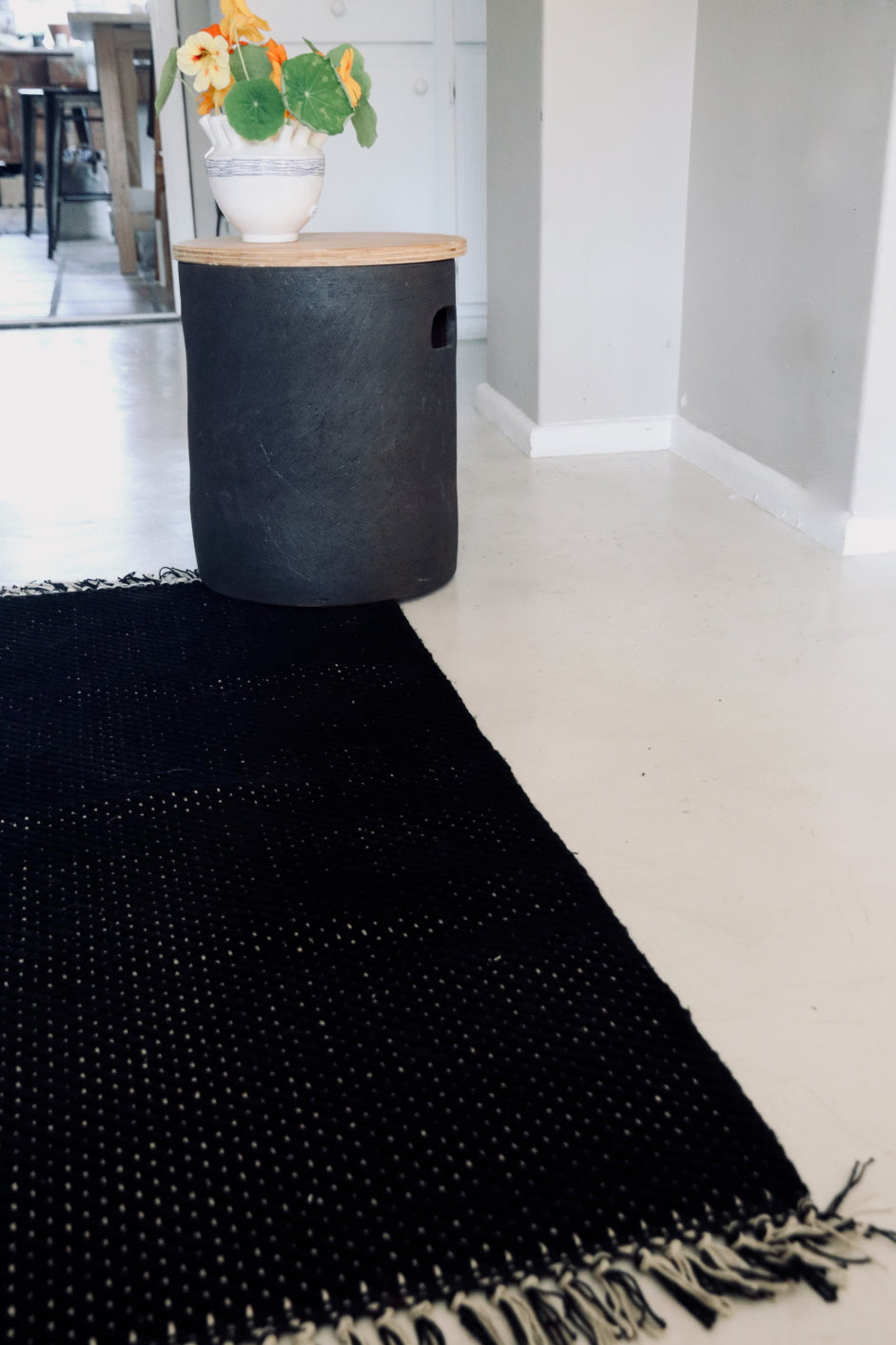 Lifestyle photo showing Herringbone Black Cotton Mat in use - Kanju Interiors