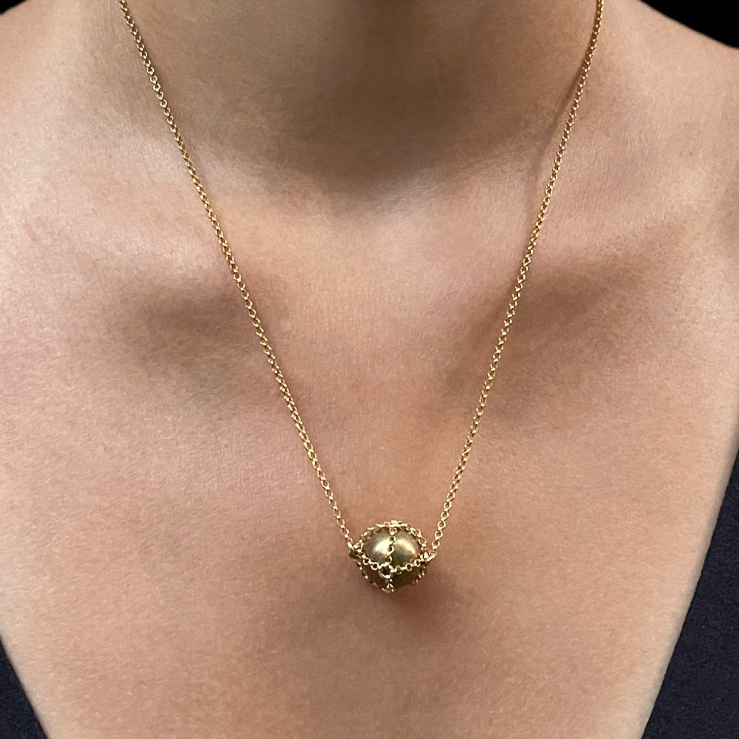Close-up detail showing quality craftsmanship and materials - Caged Gold Brass Sphere Necklace