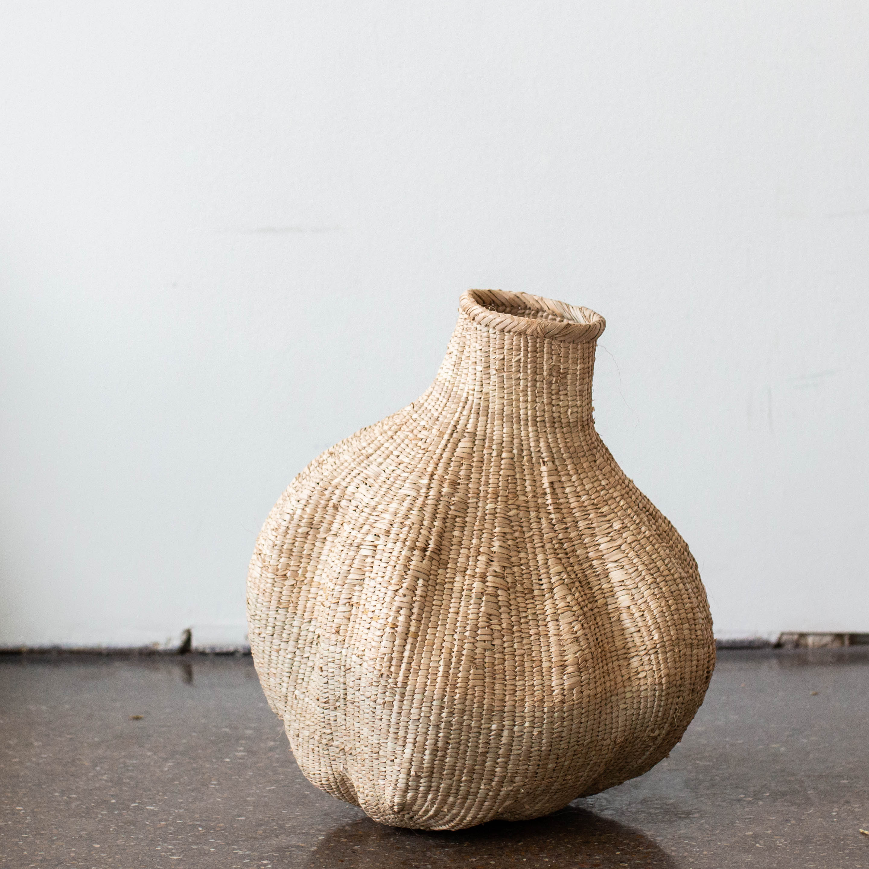 Lifestyle photo showing Ilala Garlic Gourd Handwoven African Basket in use - Kanju Interiors
