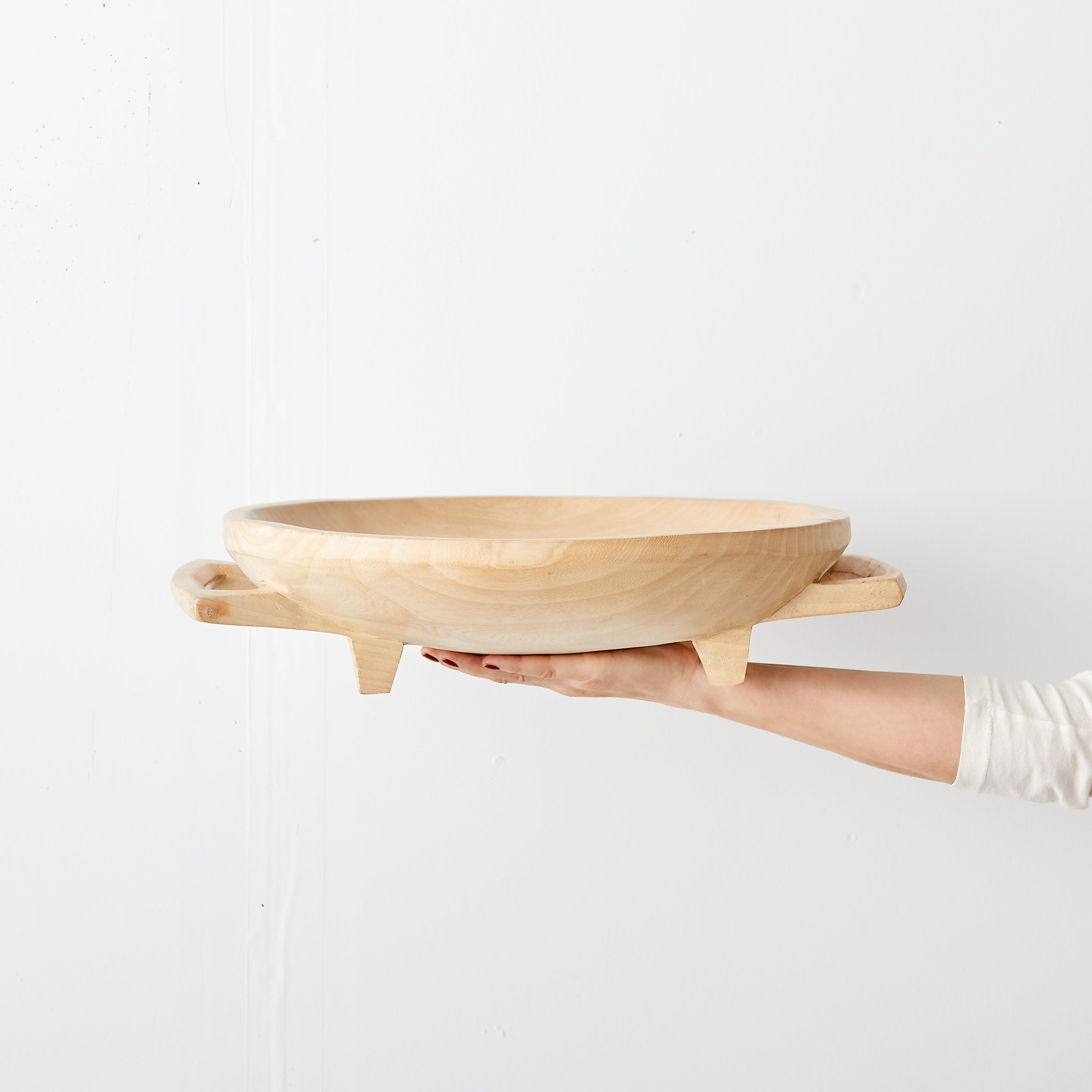 Lifestyle photo showing Swazi Round Wood Serving Platter in use - Kanju Interiors