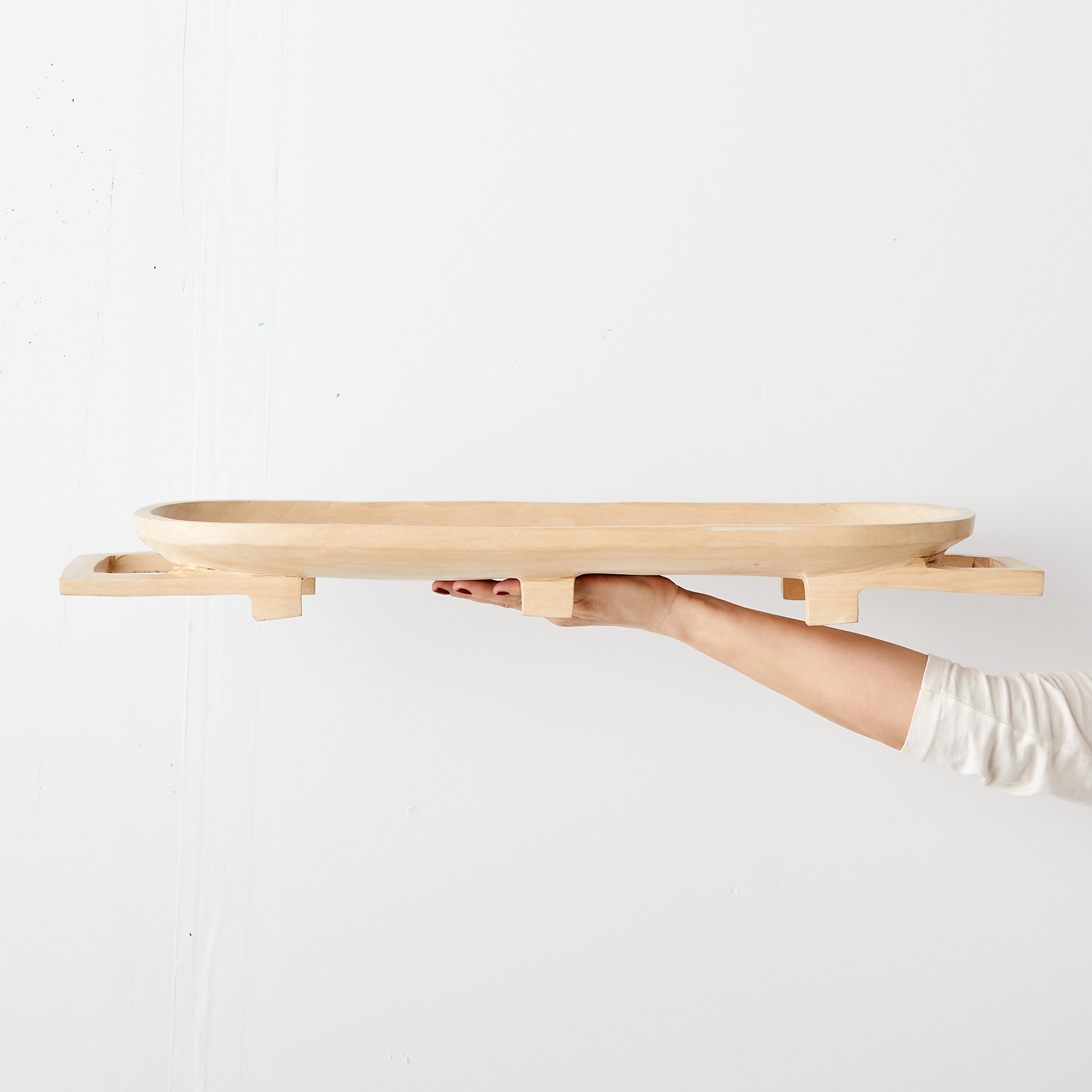 Lifestyle photo showing Swazi Long Wooden Serving Tray in use - Kanju Interiors