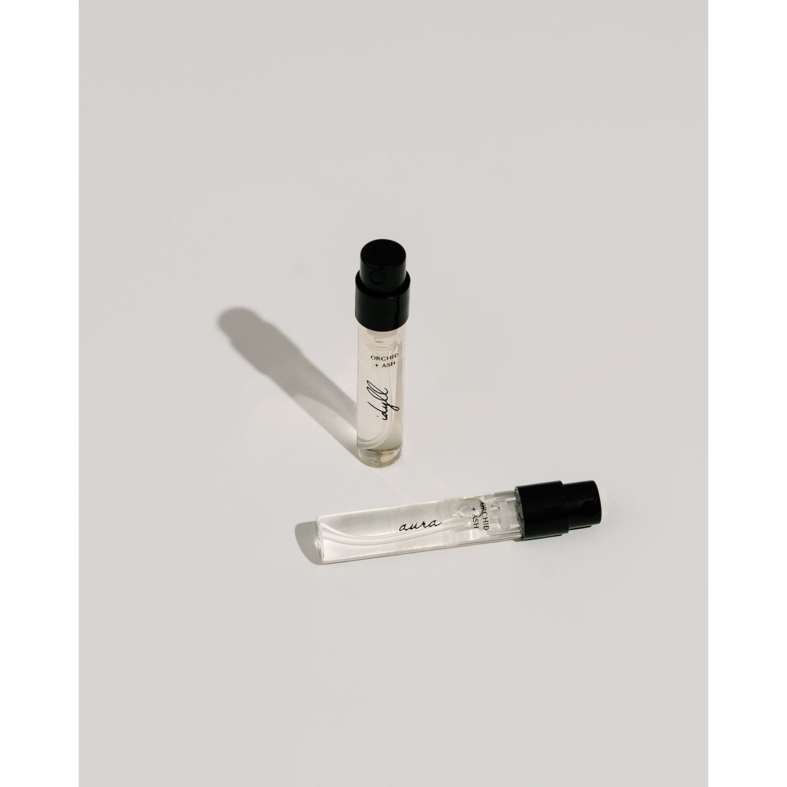 Lifestyle photo showing Perfume Discovery Kit in use - Orchid + Ash