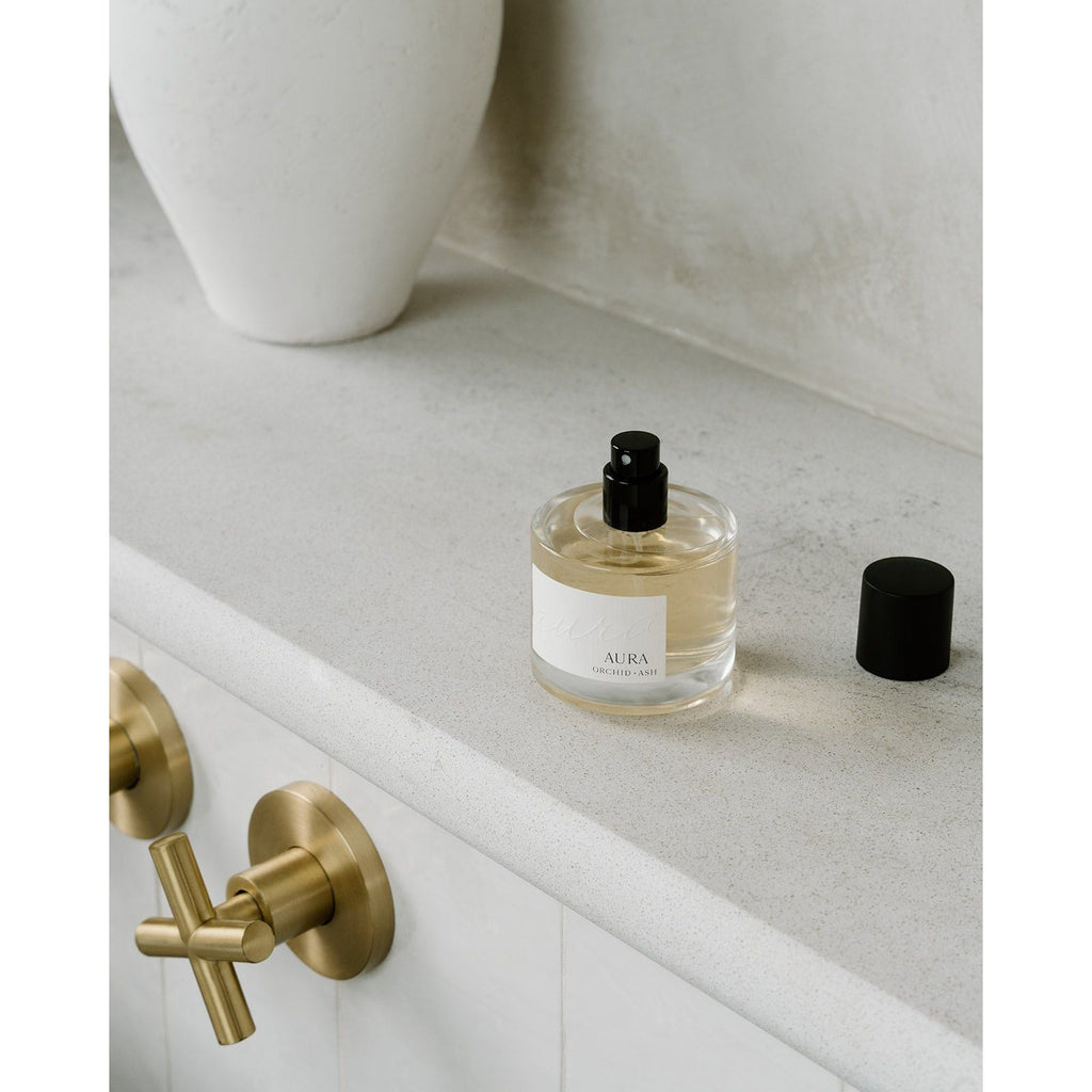 Lifestyle photo showing AURA Perfume in use - Orchid + Ash