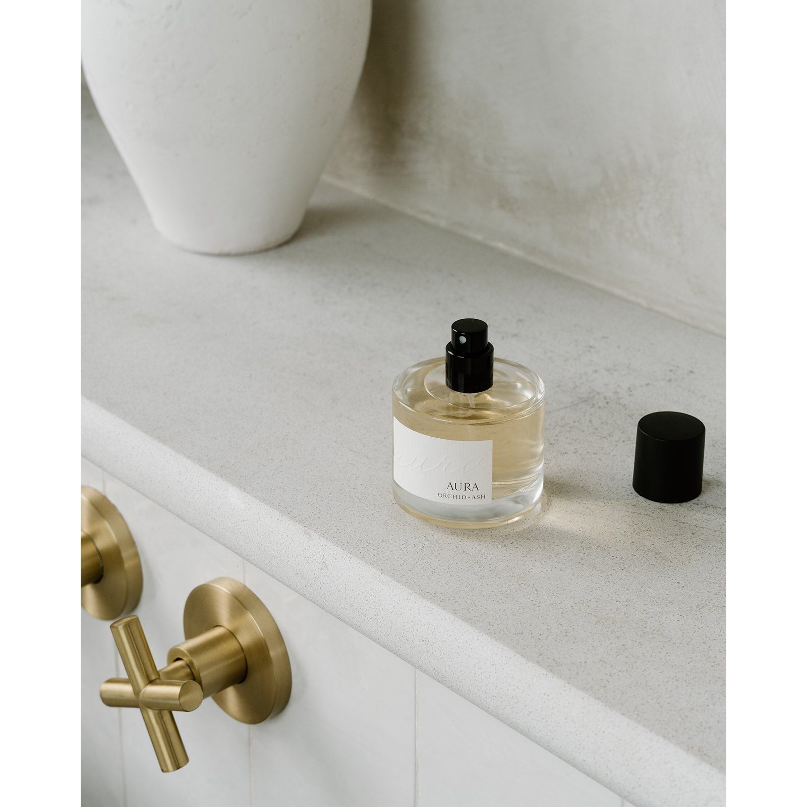 Lifestyle photo showing AURA Perfume in use - Orchid + Ash