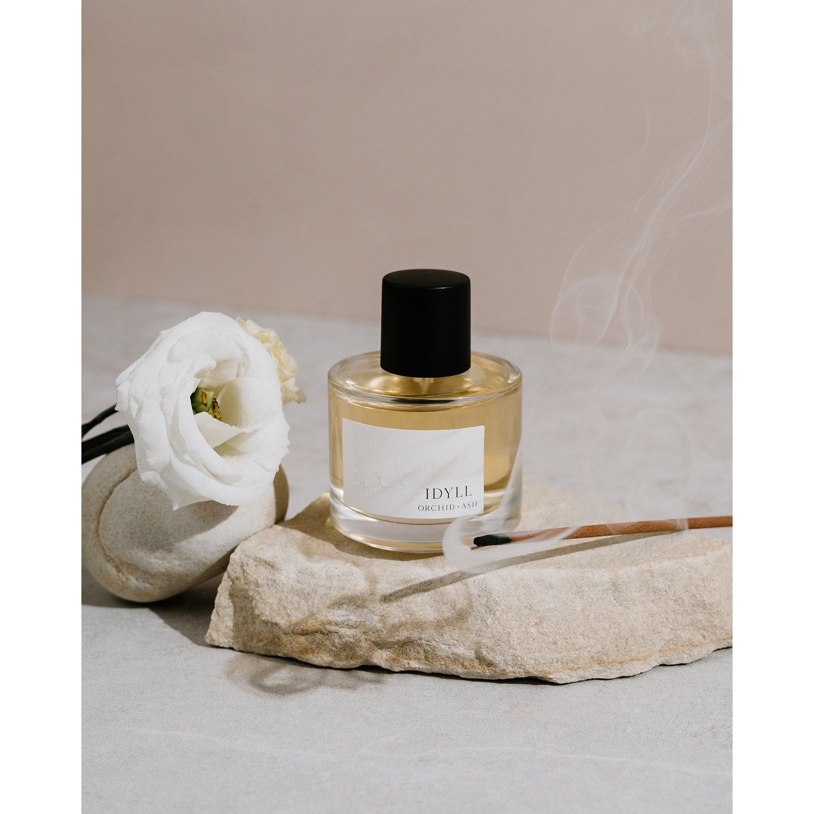 Lifestyle photo showing IDYLL Perfume in use - Orchid + Ash