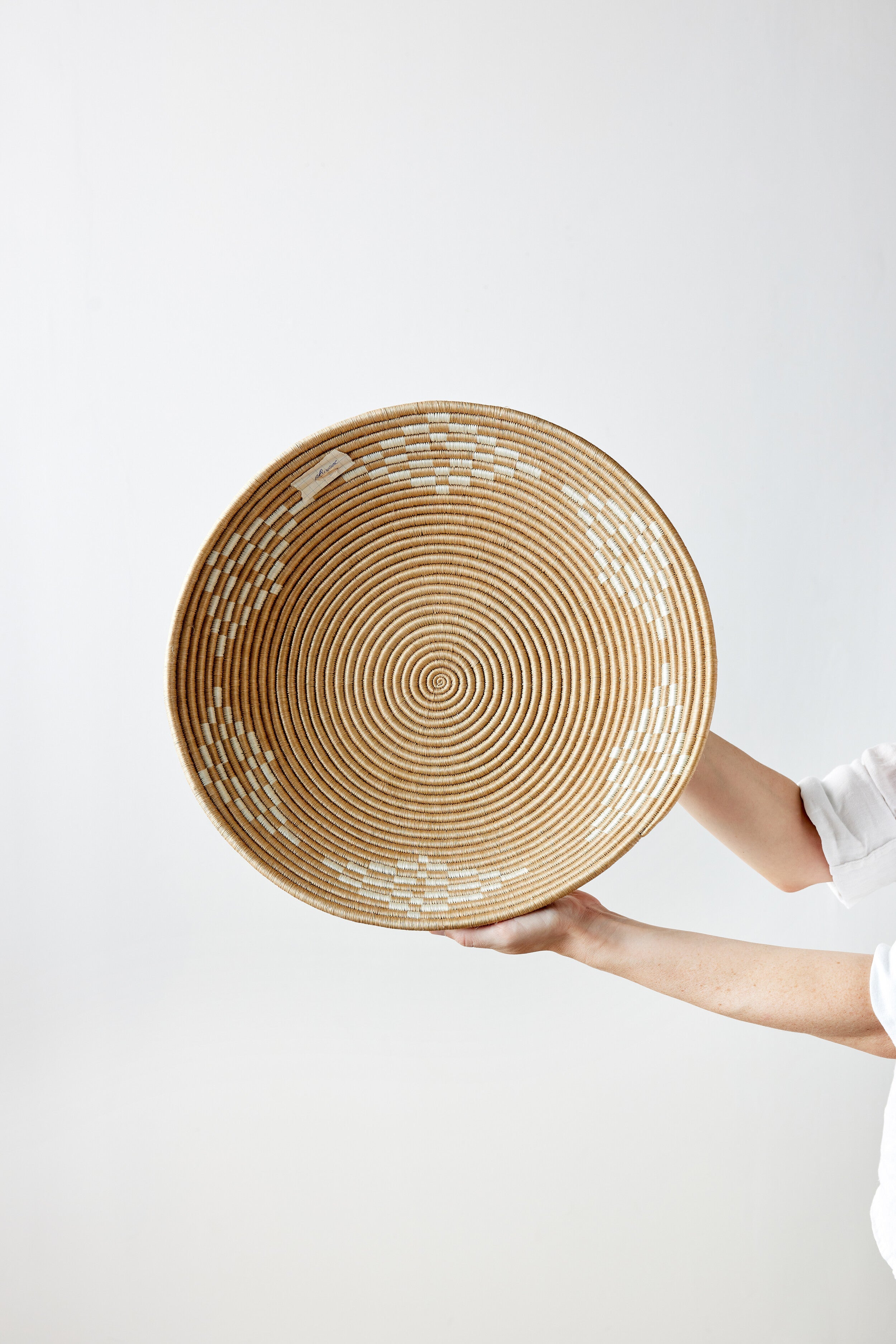 Lifestyle photo showing Blonde Rwanda Ivory Diamond Wall Basket in use - Kanju Interiors
