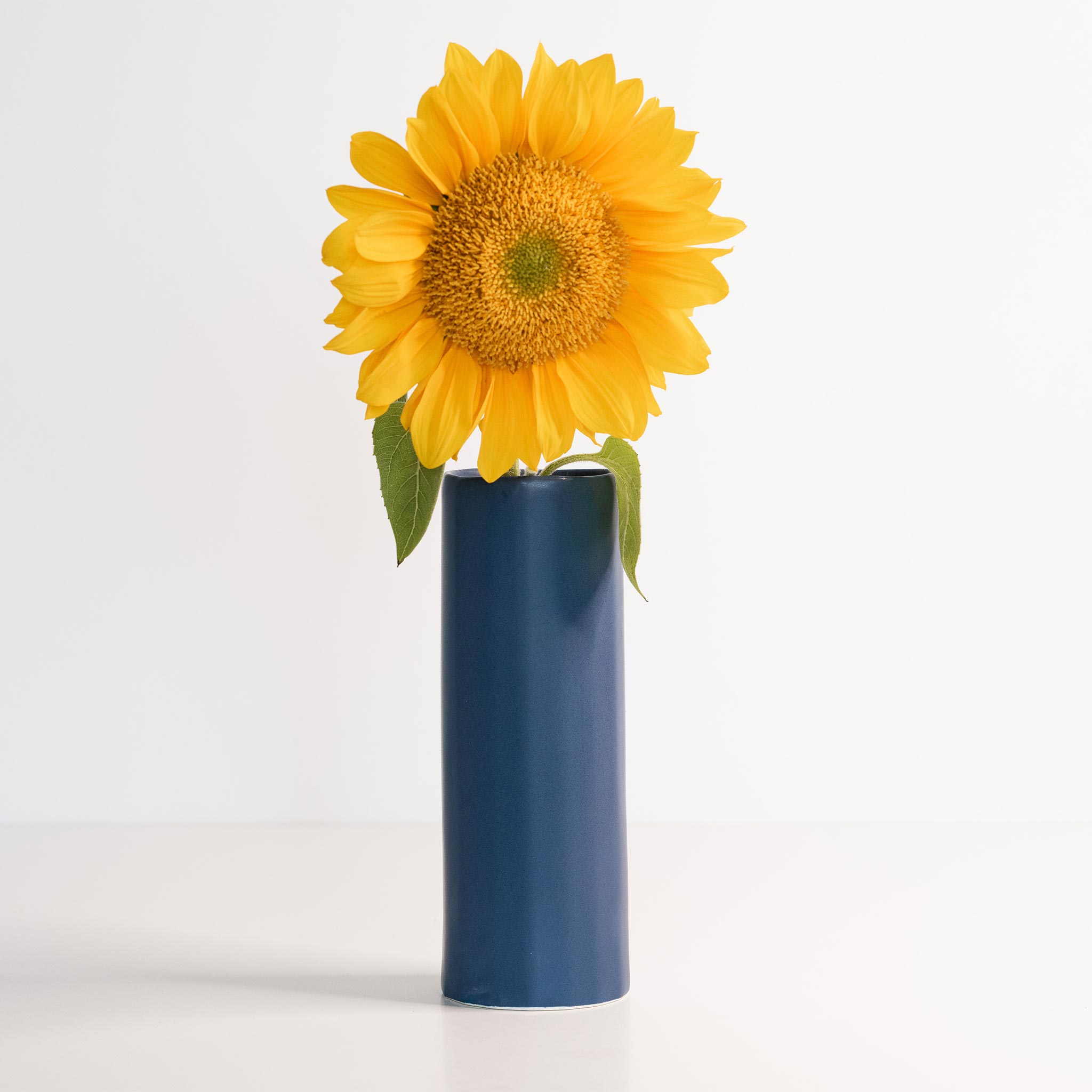 Lifestyle photo showing Bloom Vase - Handmade Porcelain Flower Vase in use - Ember Collective