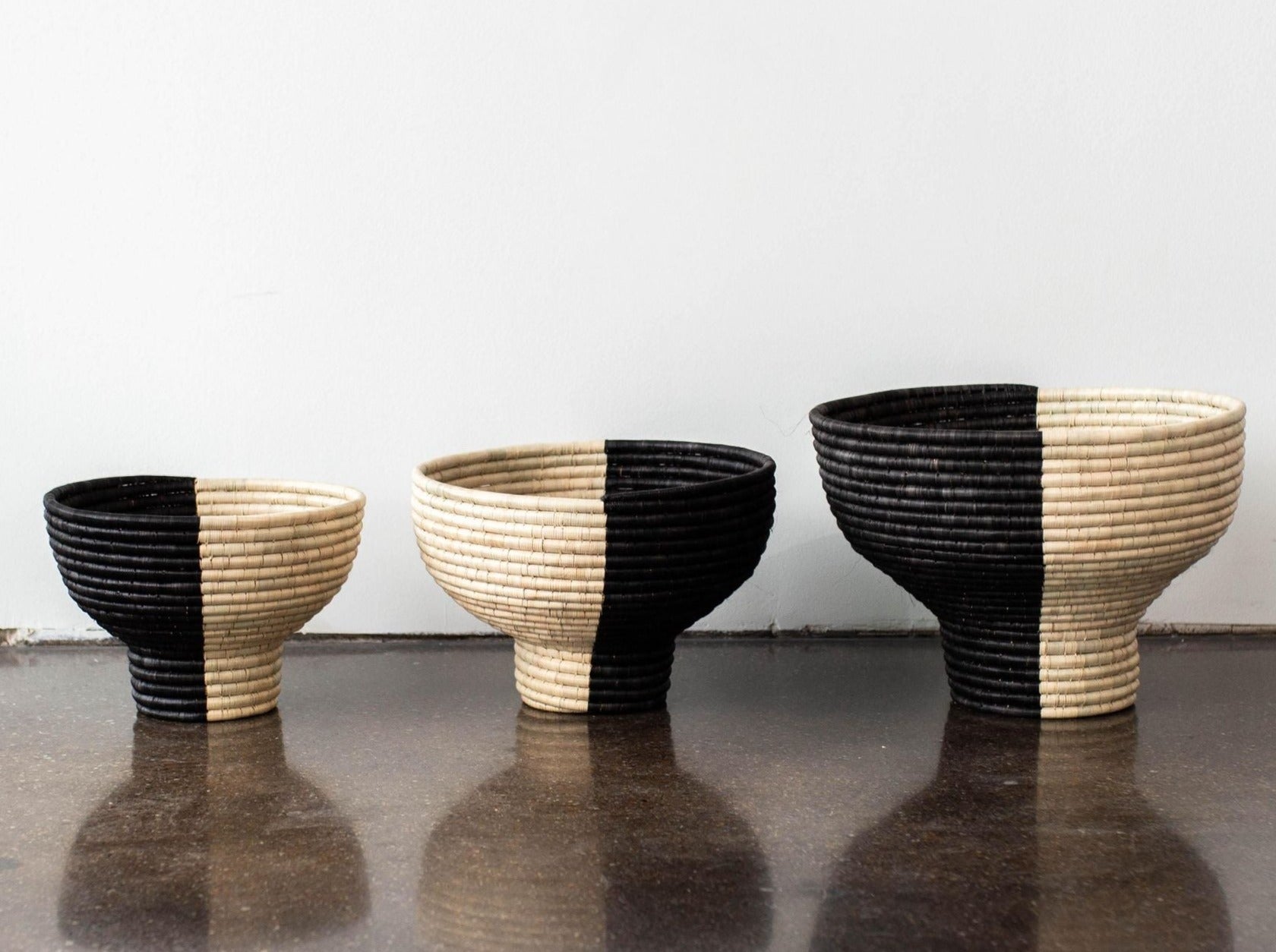 Lifestyle photo showing Pedestal Black and Natural Basket Bowl in use - Kanju Interiors