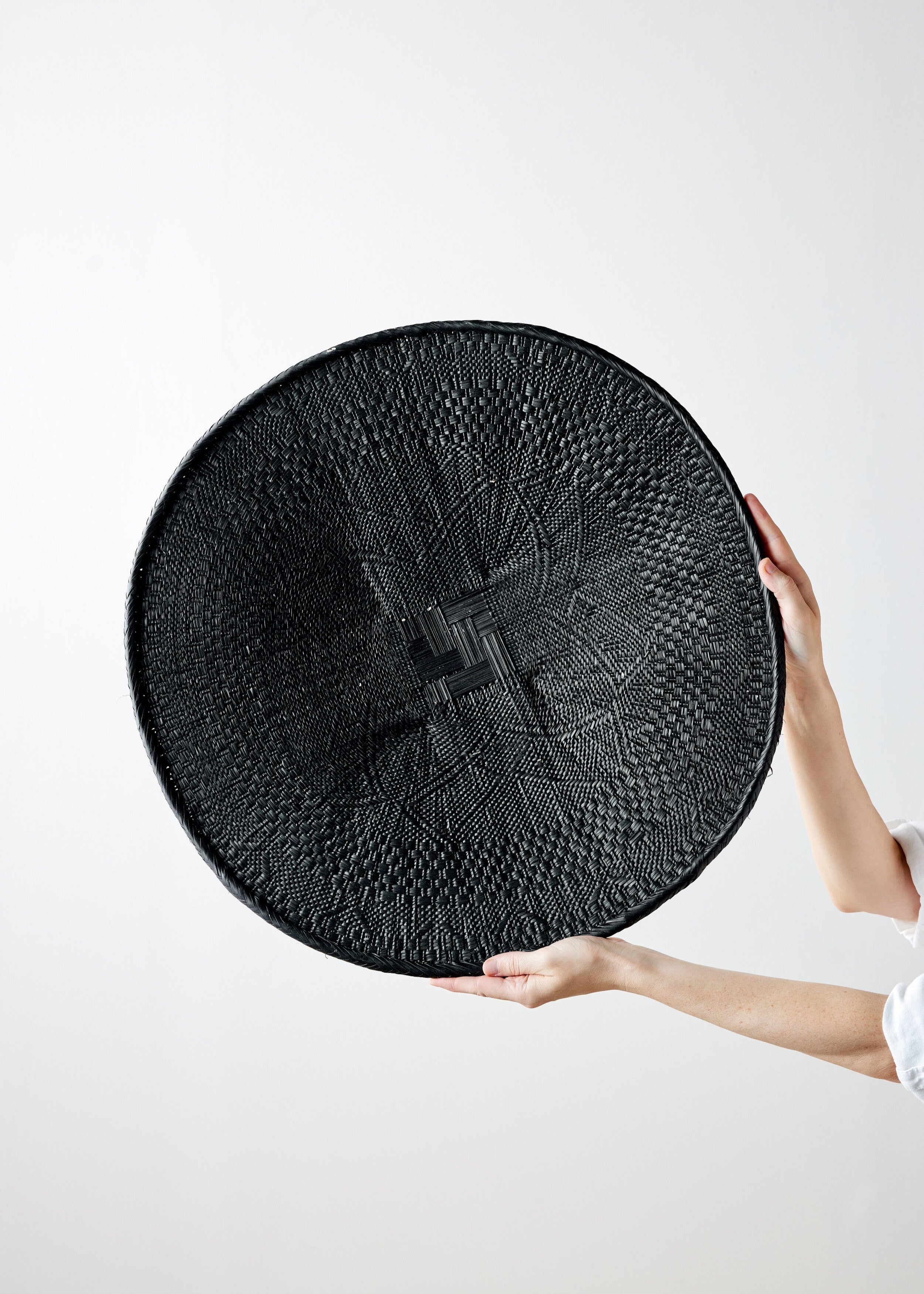 Lifestyle photo showing Hand-Painted Black Binga Flat Basket in use - Kanju Interiors