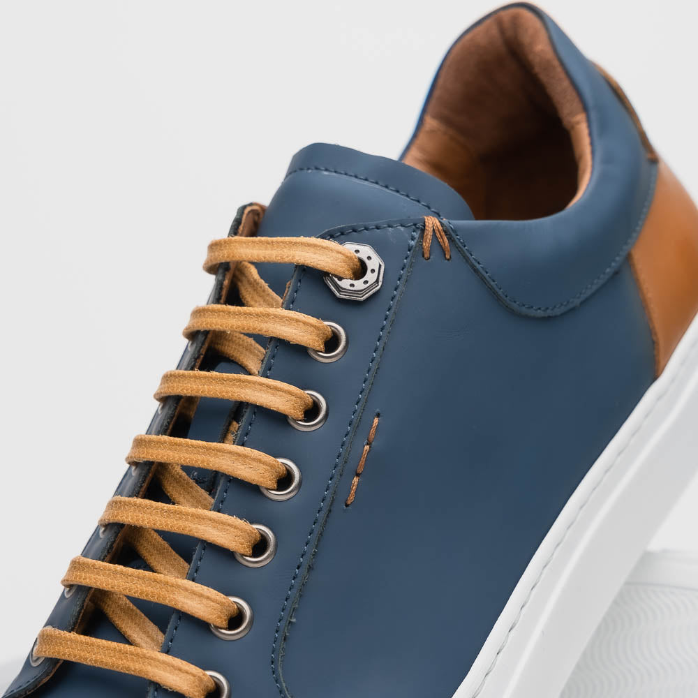 Lifestyle photo showing 65-229-NVY Diaz Rubberized Calfskin Sneaker Navy in use - Zelli Italia