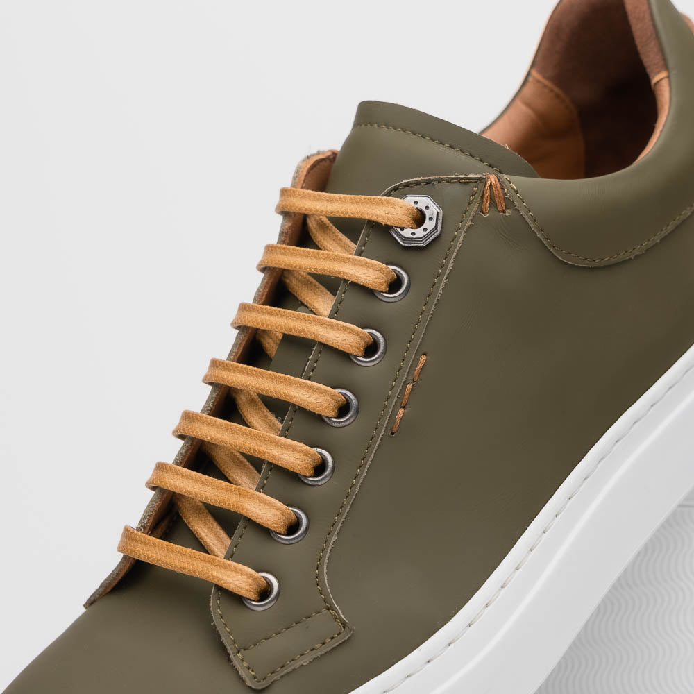 Lifestyle photo showing 65-229-OLV Diaz Rubberized Calfskin Sneaker Olive Green in use - Zelli Italia