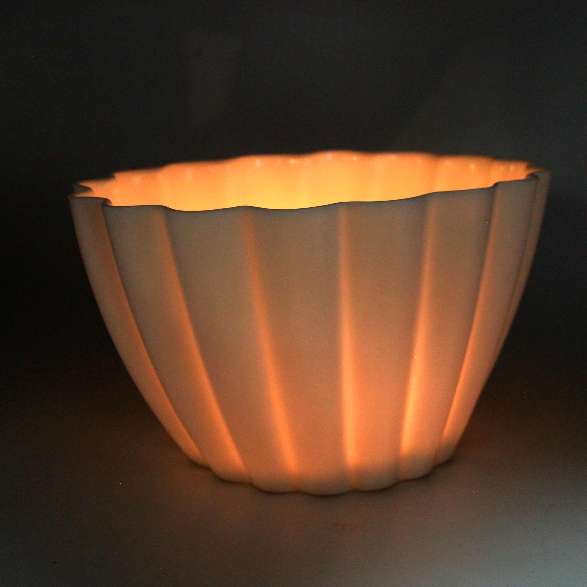 Lifestyle photo showing Elysian Fluted Porcelain Candle Holder in use - Ember Collective