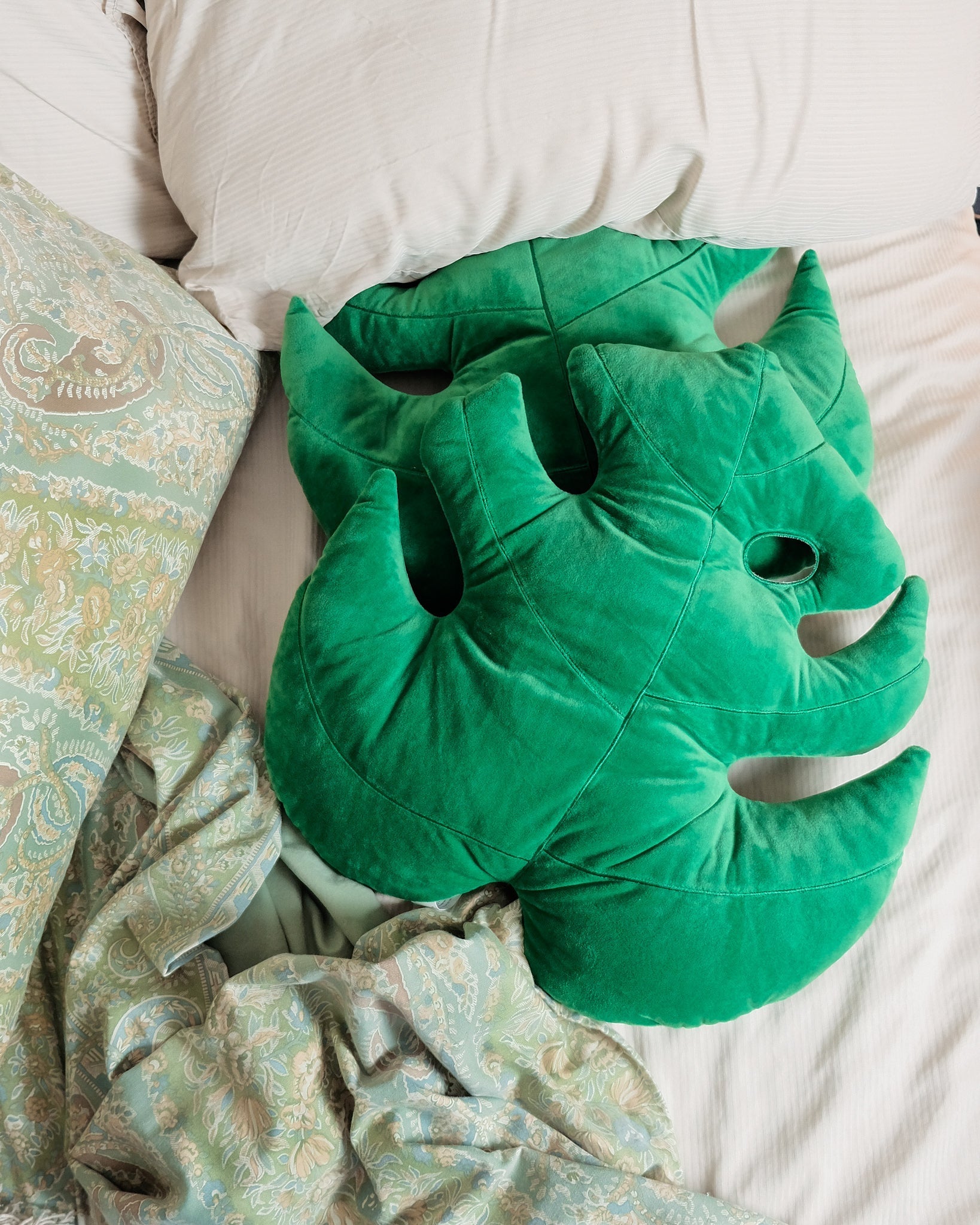 Lifestyle photo showing Monstera Deliciosa Leaf Pillow in use - Green Philosophy Co.