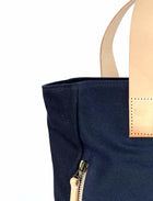 Lifestyle photo showing Navy Waxed Canvas Tote Bag - The Social Butterfly in use - notebooks & honey