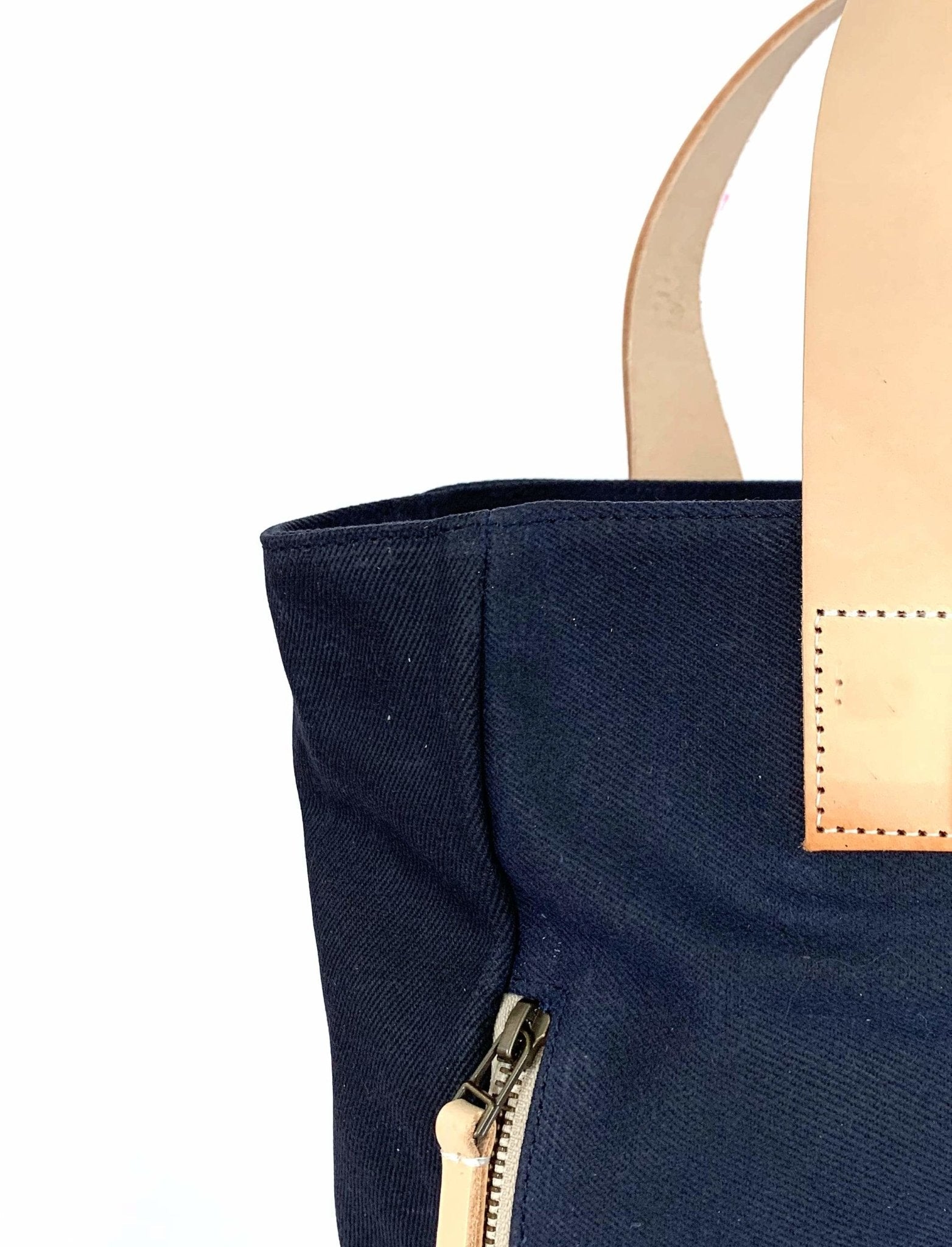 Lifestyle photo showing Navy Waxed Canvas Tote Bag - The Social Butterfly in use - notebooks & honey