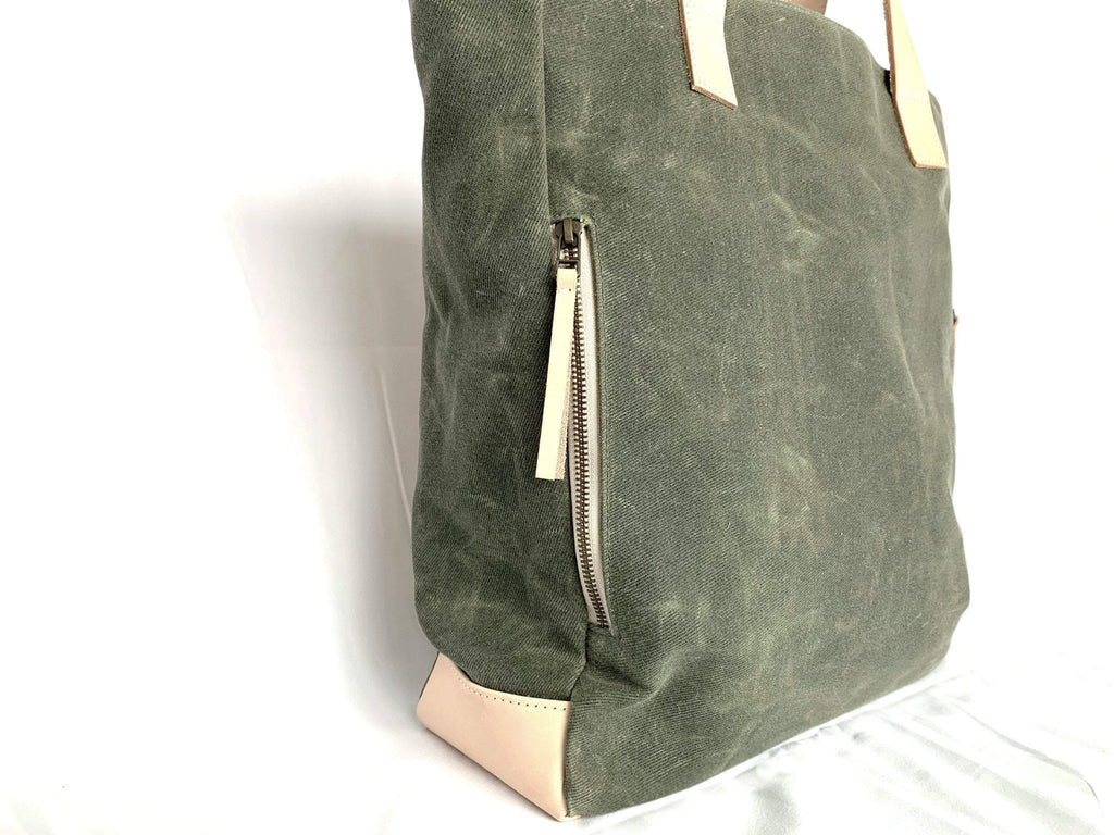 Lifestyle photo showing Olive Wax Canvas Tote Bag - The Wild One in use - notebooks & honey