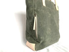 Lifestyle photo showing Olive Wax Canvas Tote Bag - The Wild One in use - notebooks & honey