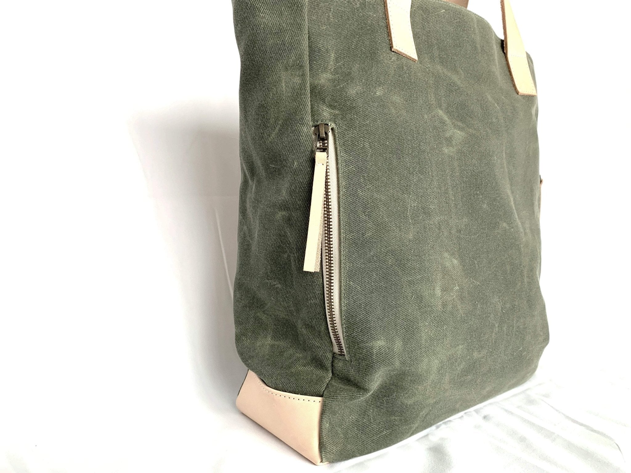 Lifestyle photo showing Olive Wax Canvas Tote Bag - The Wild One in use - notebooks & honey