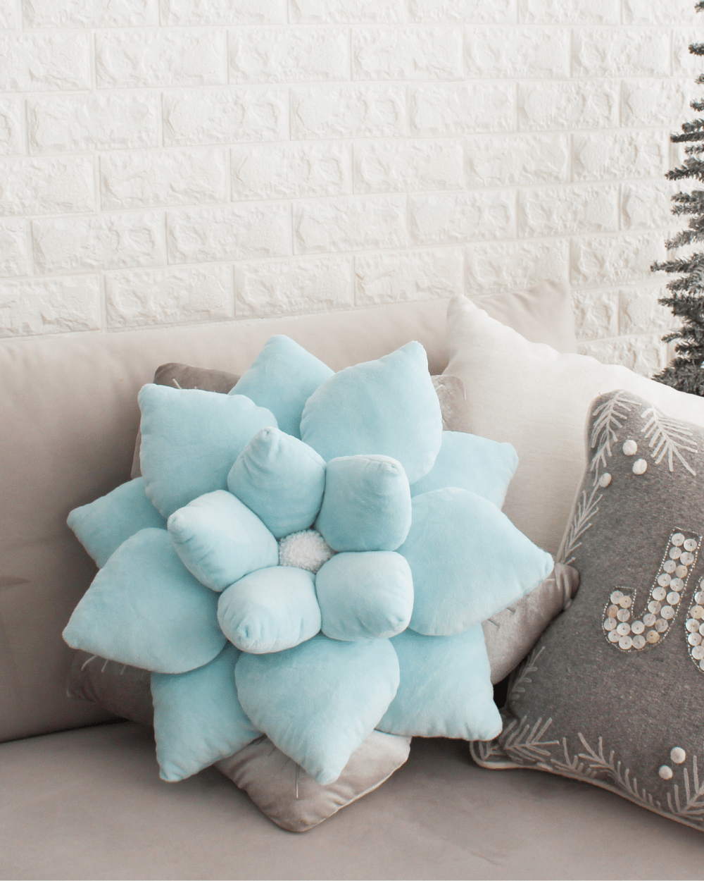 Lifestyle photo showing Poinsettia Pillow - Frost Blue in use - Green Philosophy Co.