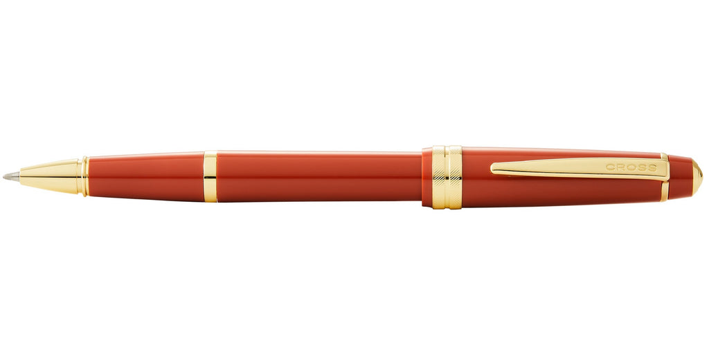 Lifestyle photo showing A.T. Cross Bailey Light Polished Amber Resin and Gold Tone Roller in use - A.T. Cross